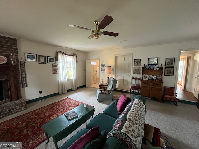 living room with ceiling fan, a brick fireplace, and light carpet