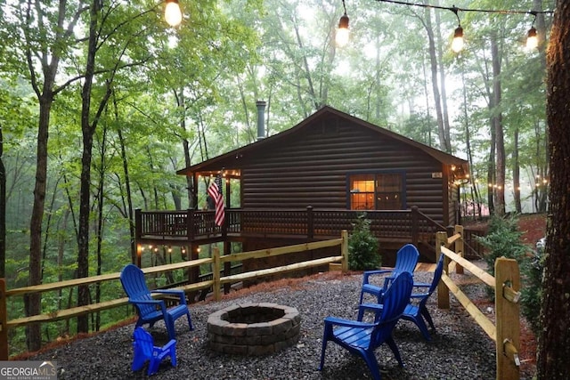 view of home's exterior featuring a fire pit and a wooden deck