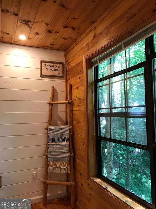 interior space featuring wooden walls and wood ceiling