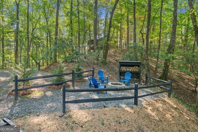 view of gate with a fire pit