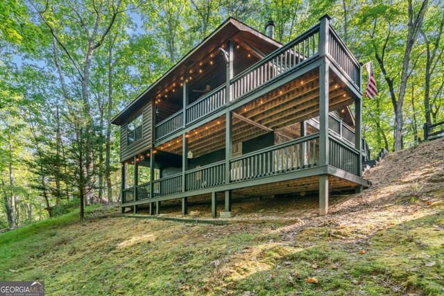 rear view of property with a wooden deck