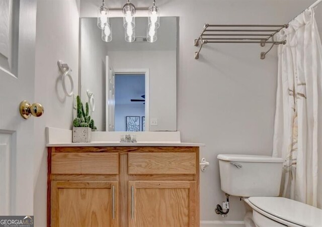 bathroom featuring vanity, toilet, and a shower with curtain