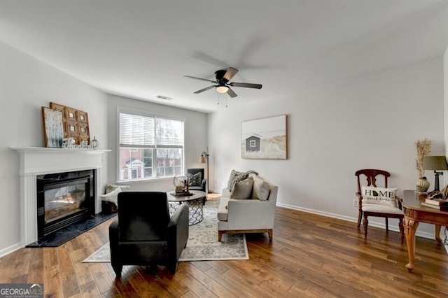 living room featuring ceiling fan and hardwood / wood-style floors