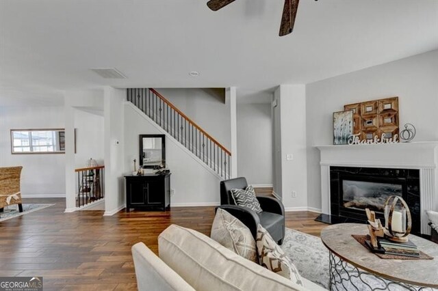 living room with a fireplace and dark hardwood / wood-style flooring