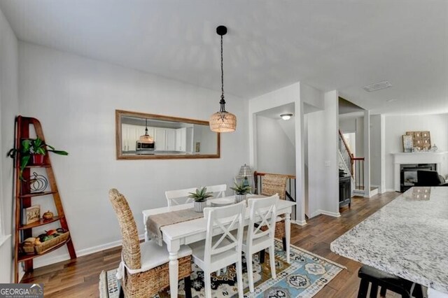 dining space with dark hardwood / wood-style floors