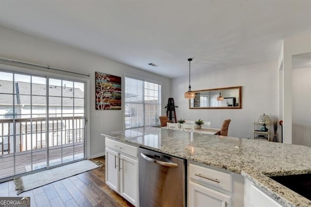 kitchen with dark hardwood / wood-style flooring, decorative light fixtures, light stone counters, white cabinets, and stainless steel dishwasher