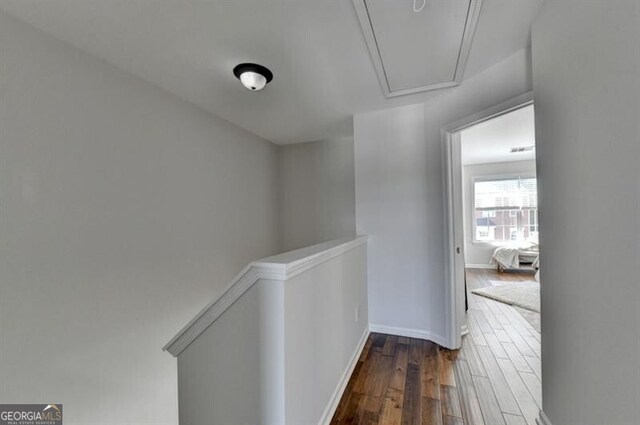 corridor with dark hardwood / wood-style flooring