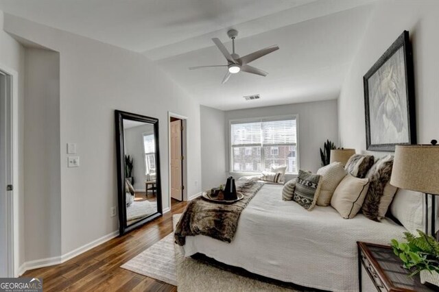 bedroom featuring dark wood-type flooring, lofted ceiling, and ceiling fan