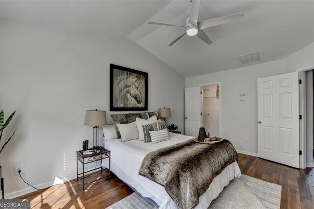 bedroom with lofted ceiling, dark hardwood / wood-style floors, and ceiling fan