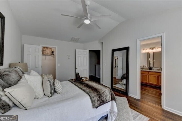 bedroom featuring ensuite bathroom, ceiling fan, a closet, lofted ceiling, and dark hardwood / wood-style floors