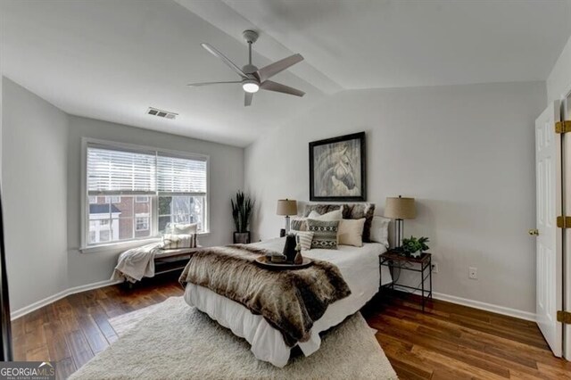 bedroom featuring ceiling fan, lofted ceiling, and dark hardwood / wood-style floors