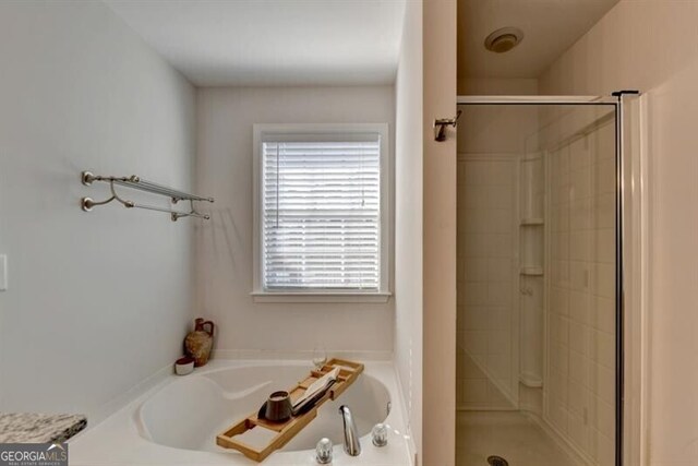 bathroom with separate shower and tub