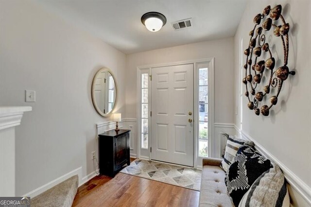 entrance foyer with a wealth of natural light and light hardwood / wood-style floors