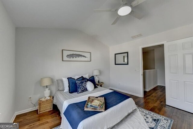 bedroom with lofted ceiling, ceiling fan, and dark wood-type flooring