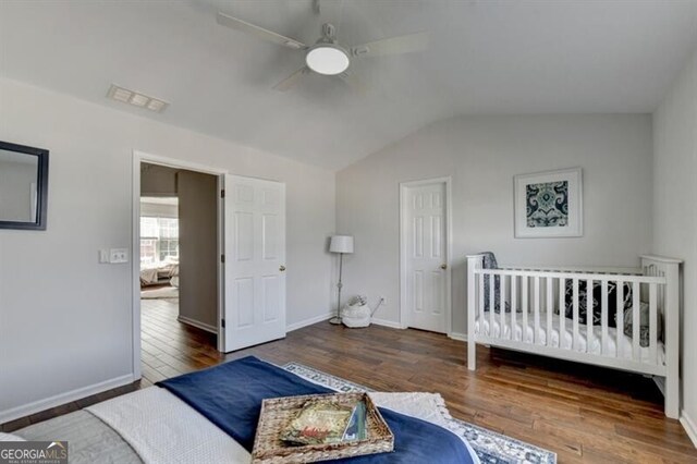 bedroom with lofted ceiling, wood-type flooring, and ceiling fan