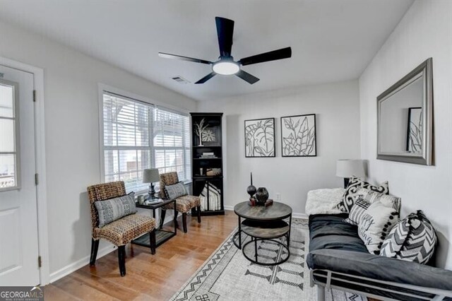 living room with ceiling fan and hardwood / wood-style floors