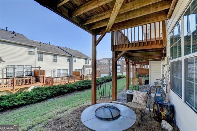 view of patio featuring a fire pit and a deck