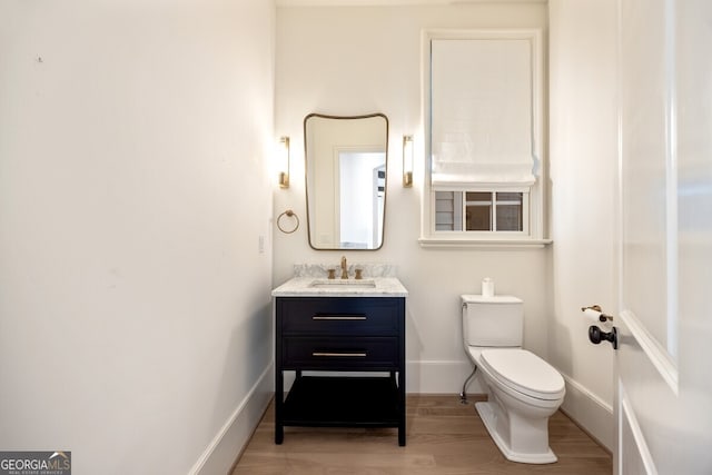 bathroom featuring hardwood / wood-style floors, vanity, and toilet