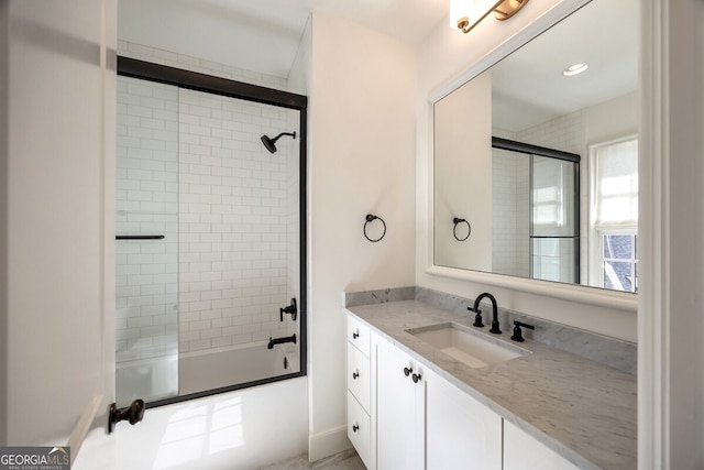 bathroom with shower / bath combination with glass door and vanity