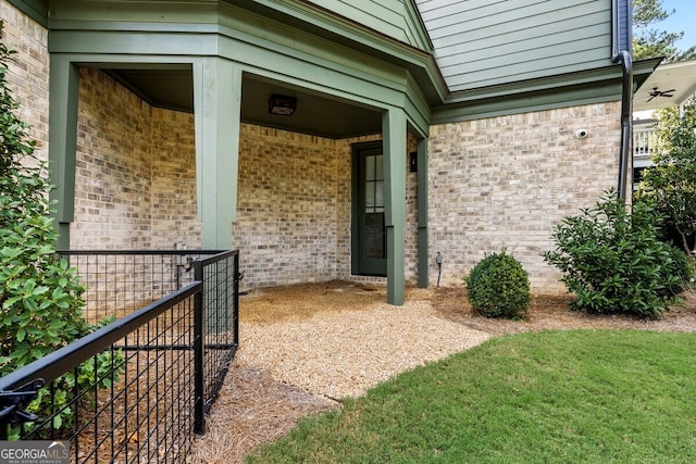 entrance to property featuring a lawn