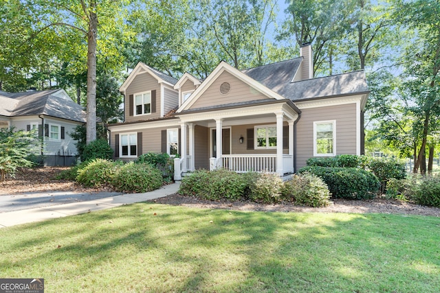 view of front facade featuring covered porch and a front yard