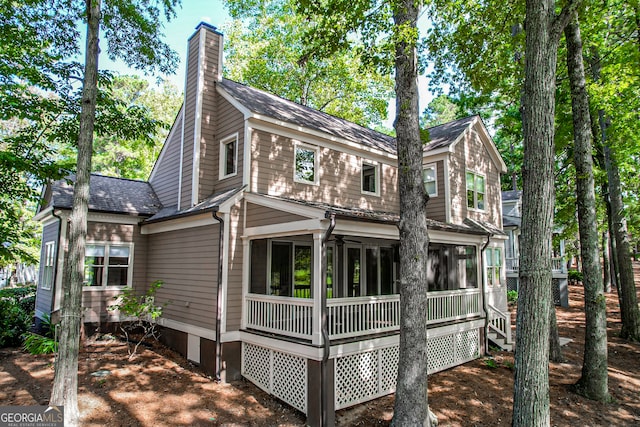 back of property featuring a sunroom