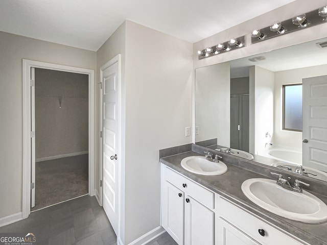 bathroom with vanity and a washtub