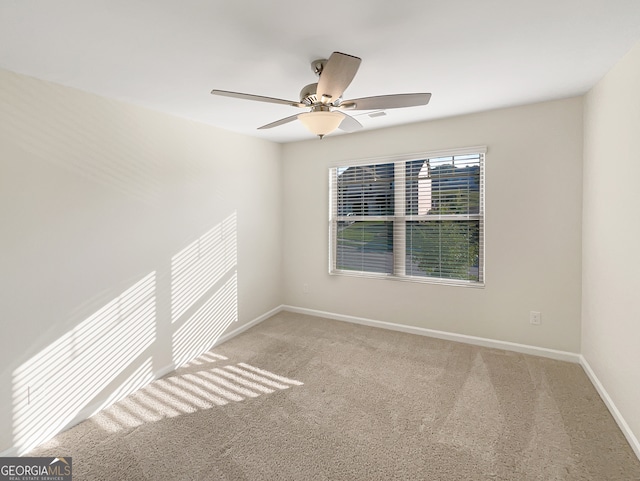 spare room with ceiling fan and carpet floors