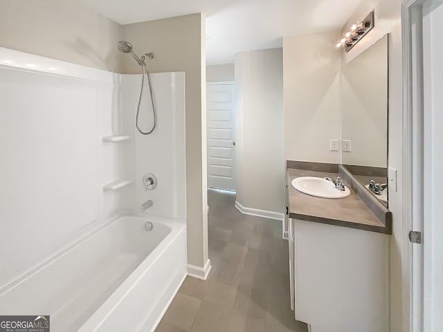 bathroom featuring  shower combination and vanity