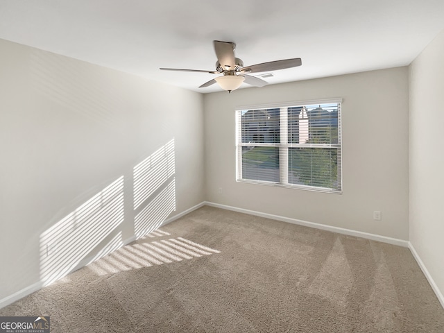 empty room with ceiling fan and carpet