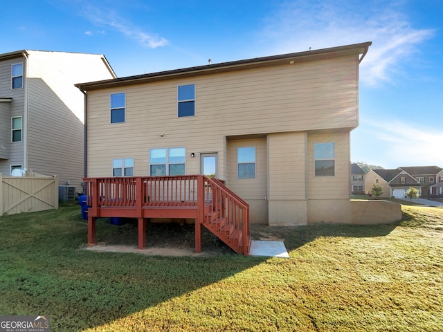 back of house with a yard and a deck