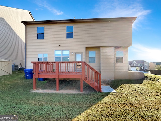 rear view of property featuring cooling unit, a yard, and a deck