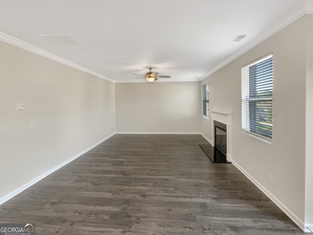 unfurnished living room featuring ceiling fan, ornamental molding, and dark wood-type flooring