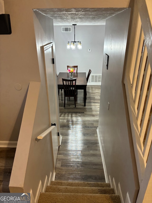 1126 Mainstreet Valley Dr, Stone Mountain, GA 30088 - stairway featuring hardwood / wood-style flooring and a chandelier