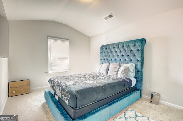 bedroom featuring vaulted ceiling and carpet flooring