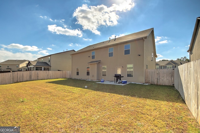 back of house featuring a yard and a patio area