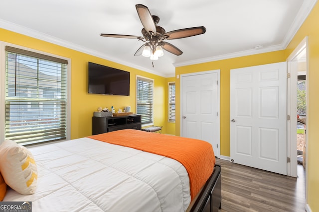 bedroom with crown molding, ceiling fan, and wood-type flooring