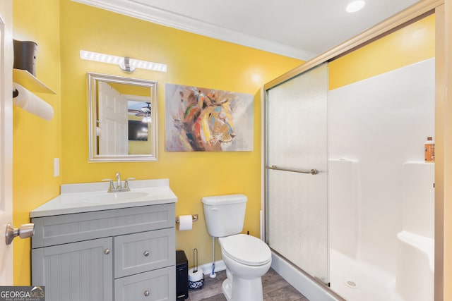 bathroom featuring vanity, tile patterned flooring, a shower with shower door, ornamental molding, and toilet