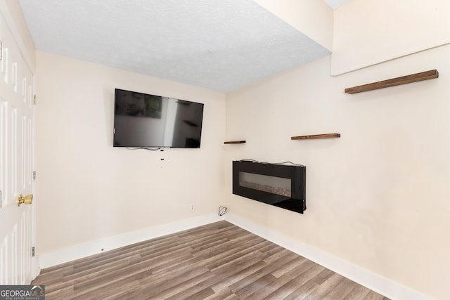 empty room featuring hardwood / wood-style floors and a textured ceiling