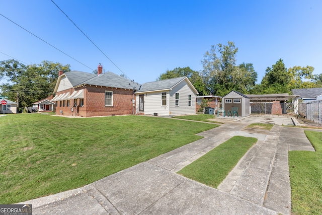 view of front facade with a storage unit and a front lawn