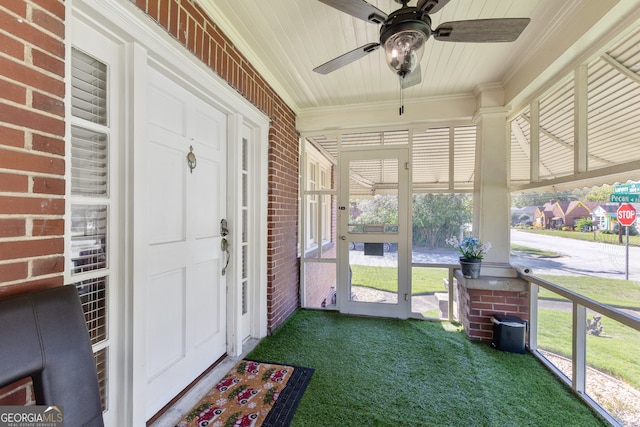 unfurnished sunroom with ceiling fan