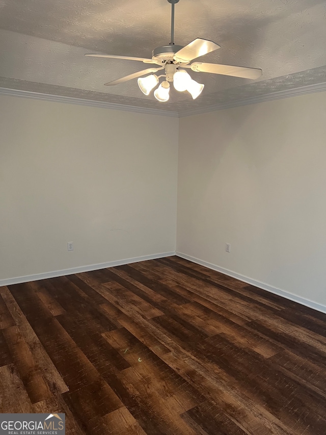 empty room featuring dark wood-type flooring, ornamental molding, a textured ceiling, and ceiling fan