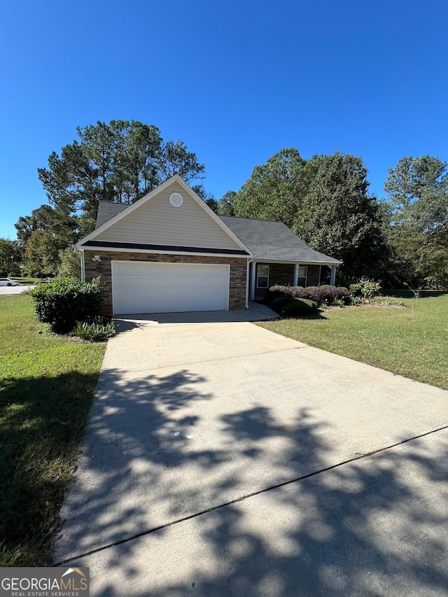 view of front of house featuring a front yard and a garage