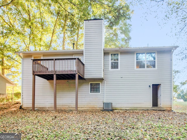 back of property with central AC and a deck