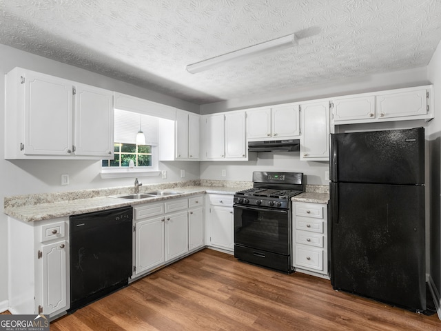 kitchen with black appliances, sink, a textured ceiling, dark hardwood / wood-style flooring, and white cabinets