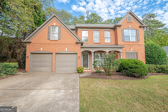 view of front of home featuring a garage and a front lawn