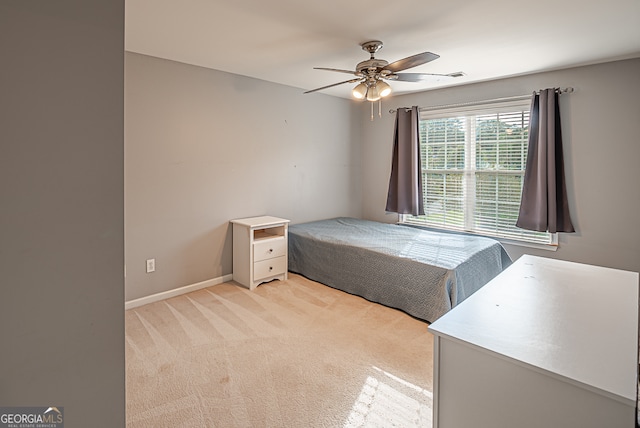 bedroom with ceiling fan and light colored carpet