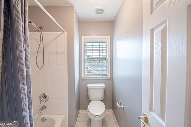 bathroom featuring shower / bath combo, tile patterned flooring, and toilet