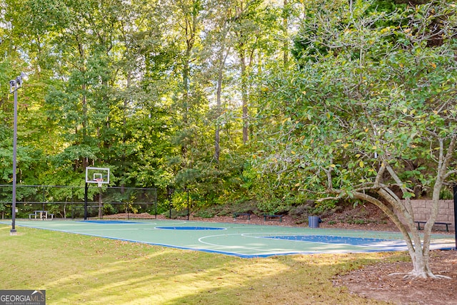 view of sport court featuring a lawn