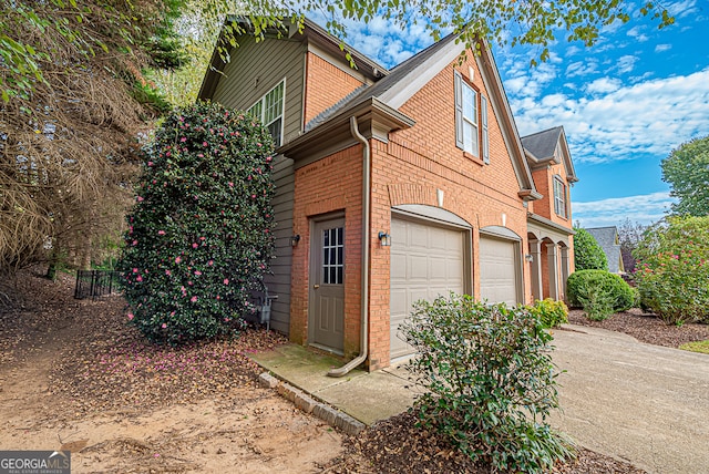 view of side of home with a garage